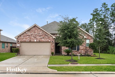 front view of a brick house with a garage