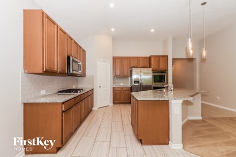 a kitchen with wooden cabinets and stainless steel appliances
