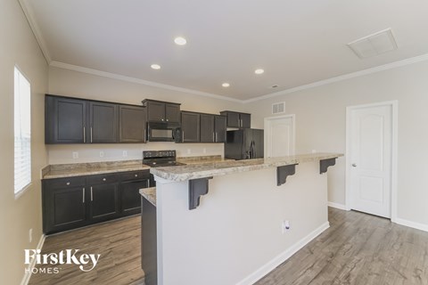 a kitchen with black cabinets and a white counter top