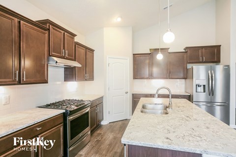 a kitchen with stainless steel appliances and marble counter tops