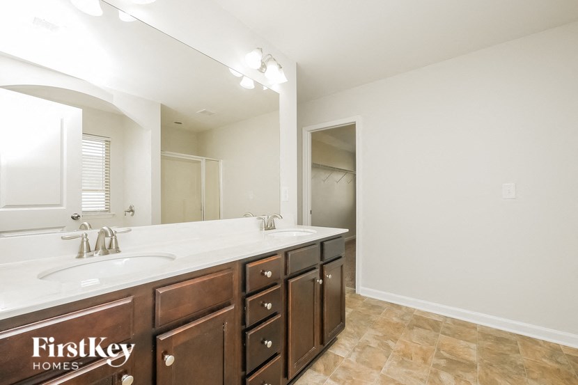 A bathroom with a double sink and a large mirror.