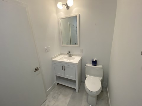 a small bathroom with a sink toilet and mirror