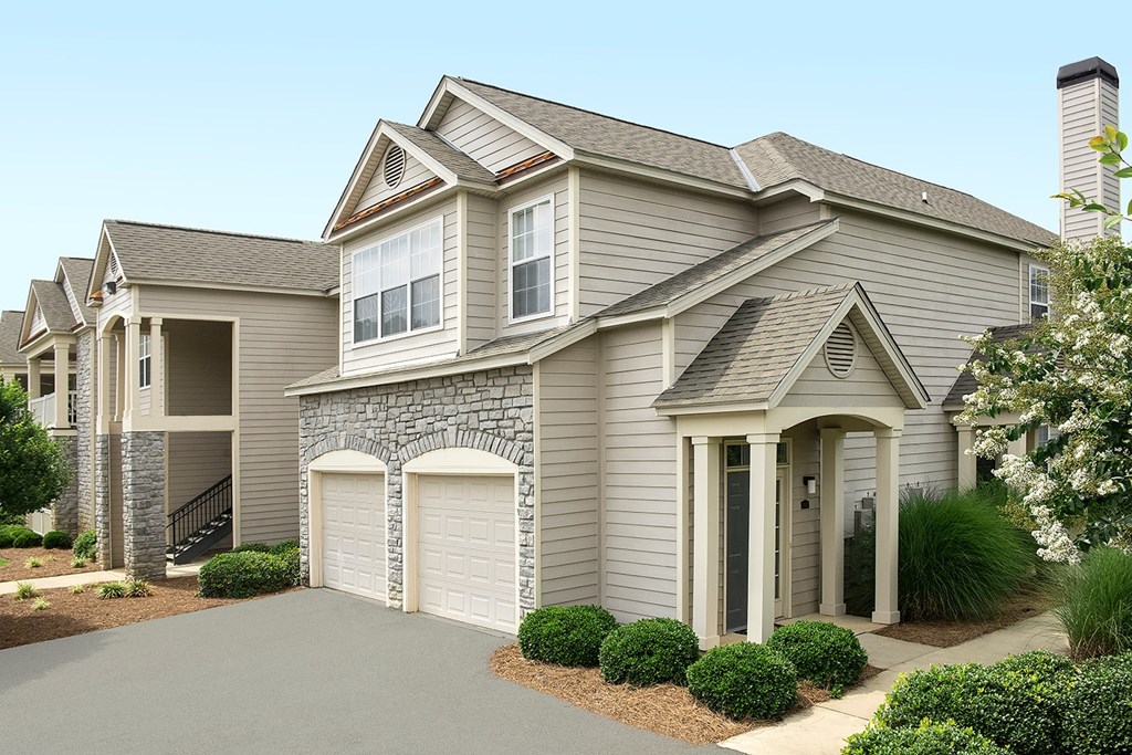 A house with a grey roof and a stone pillar.