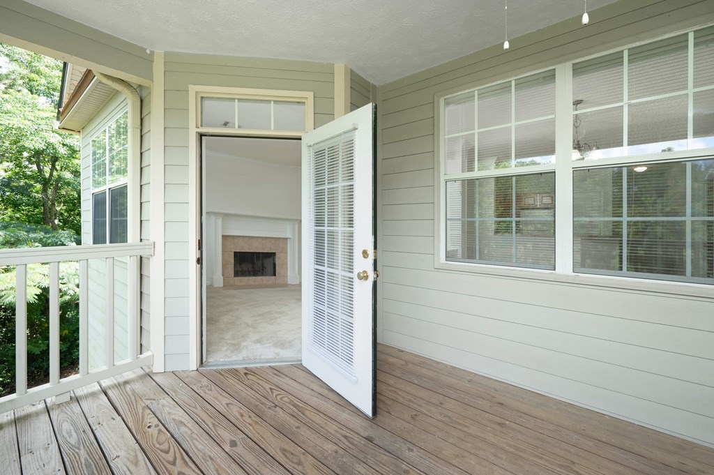 A white door is open to a room with a fireplace.