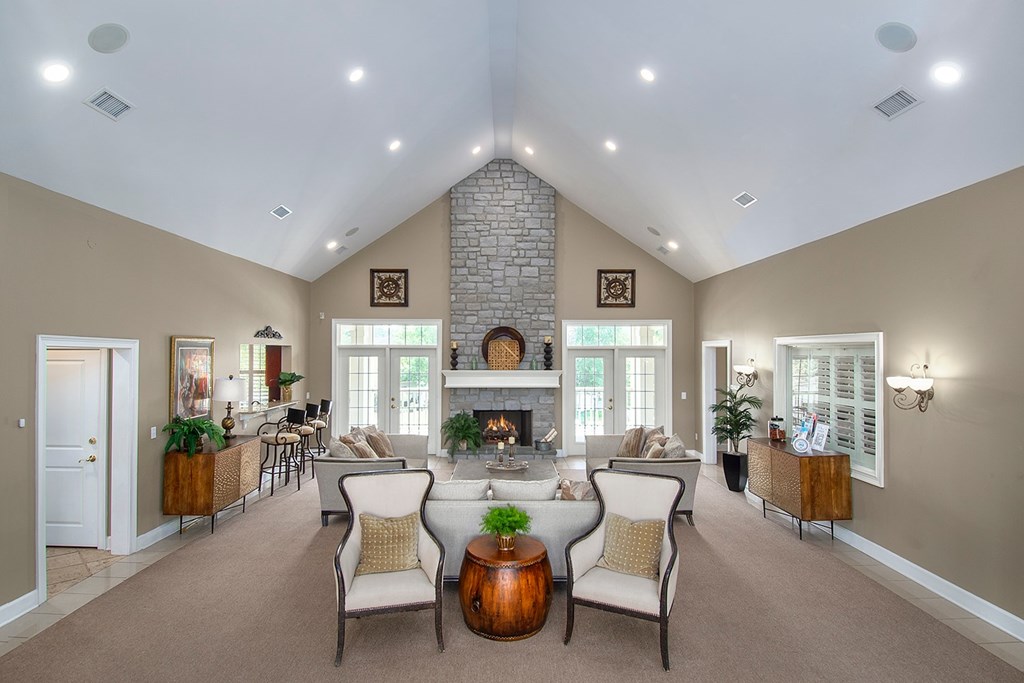 A living room with a fireplace and a large mirror on the wall.