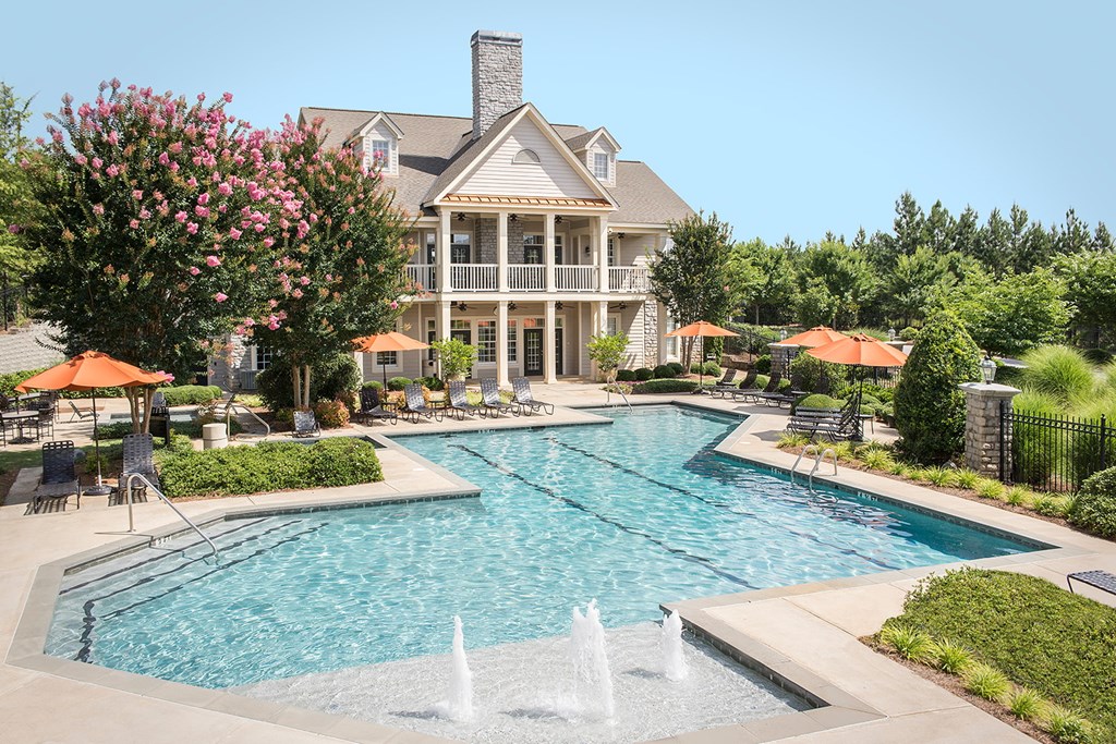 A large house with a pool in front of it.