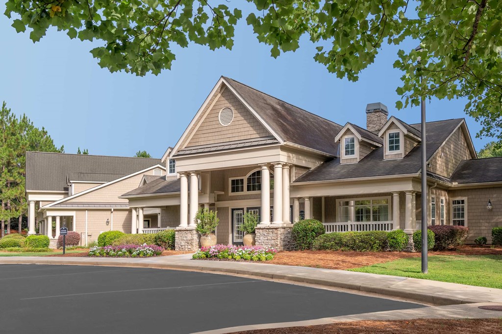 A large house with a grey roof and a chimney.