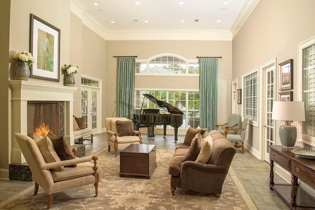 A living room with a fireplace and a piano.