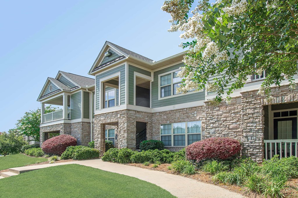 A house with a green lawn and a clear blue sky.