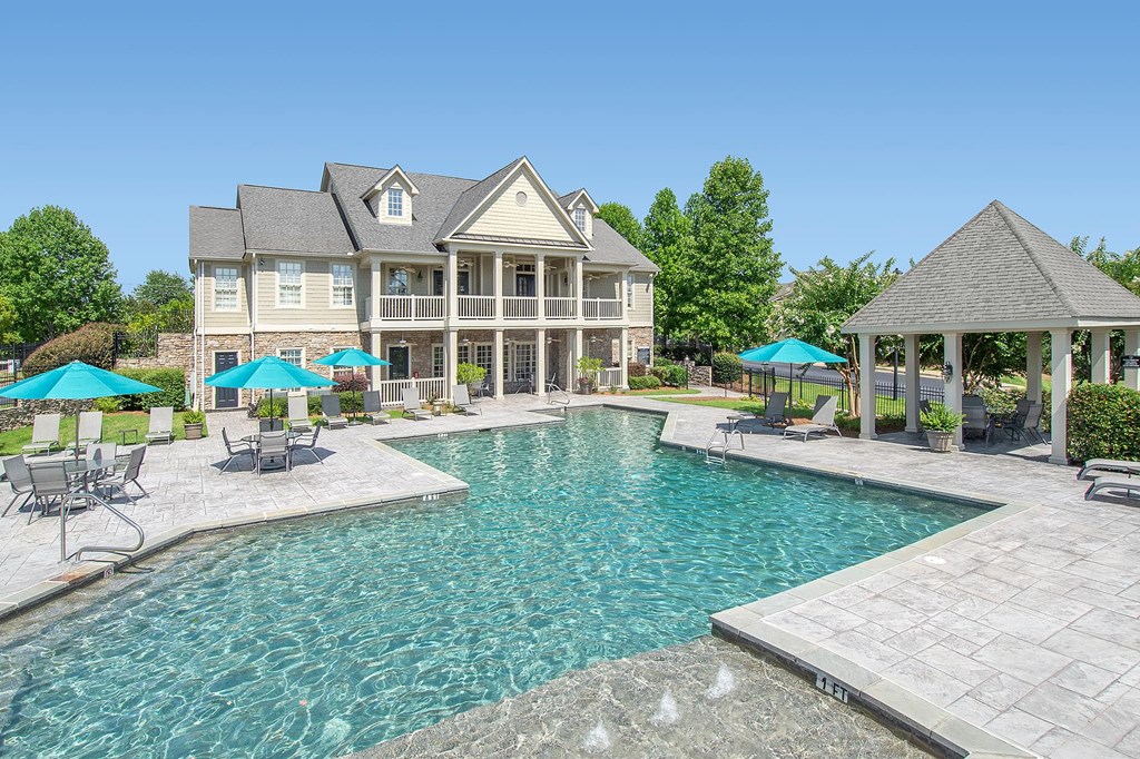 A large house with a pool in the backyard.