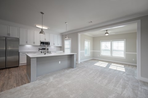 A spacious kitchen with stainless steel appliances and a large island.