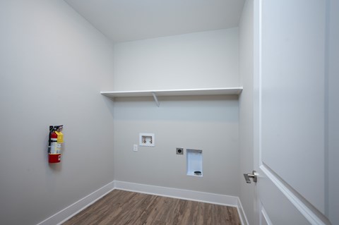 A room with a fire extinguisher on the wall.