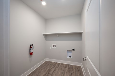 A room with a fire extinguisher on the wall.