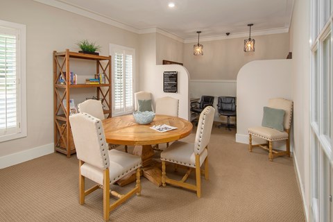 A dining room with a round table and chairs.