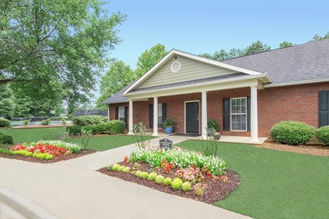A house with a front yard and a flower bed.