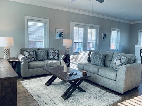A living room with two grey couches and a coffee table.
