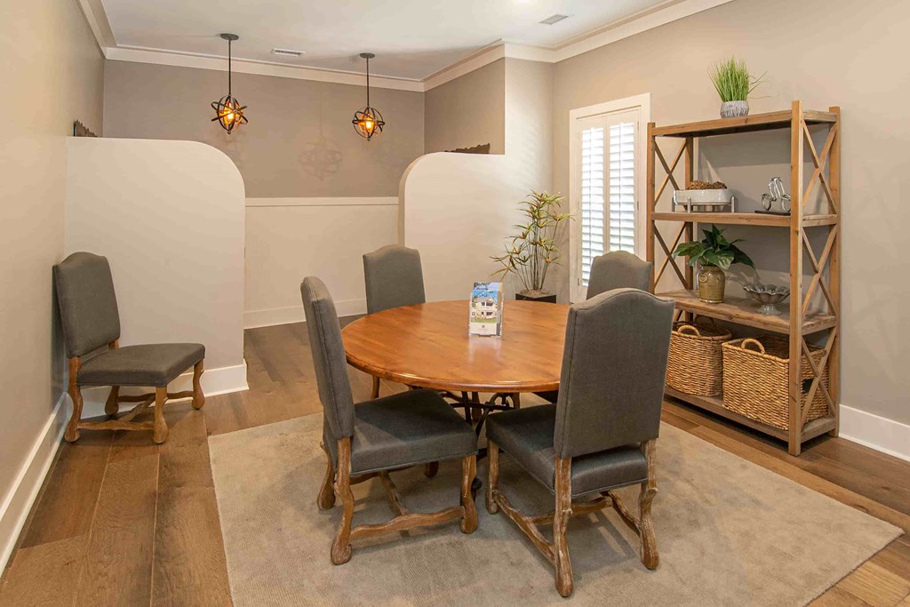 A dining room with a wooden table and chairs.