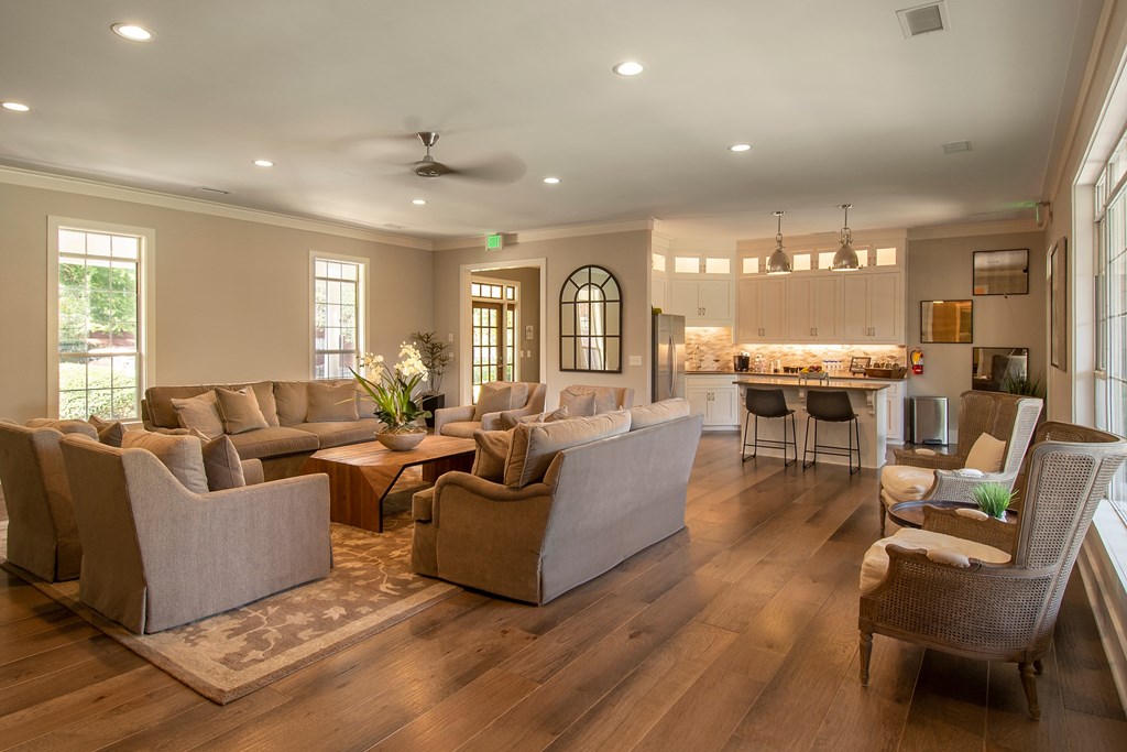 A living room with a couch, chairs, and a dining table.