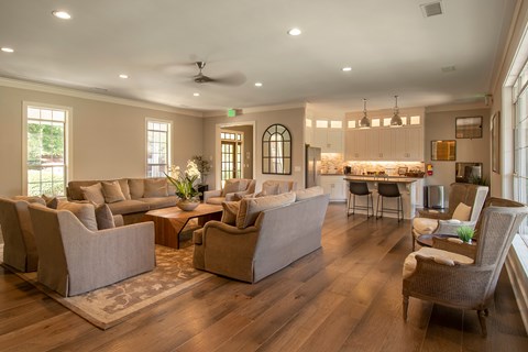 A living room with a couch, chairs, and a dining table.