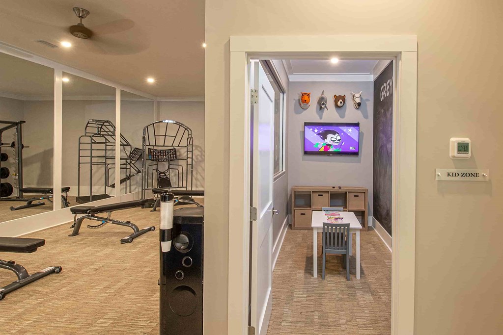 A room with a gym and a kid zone.