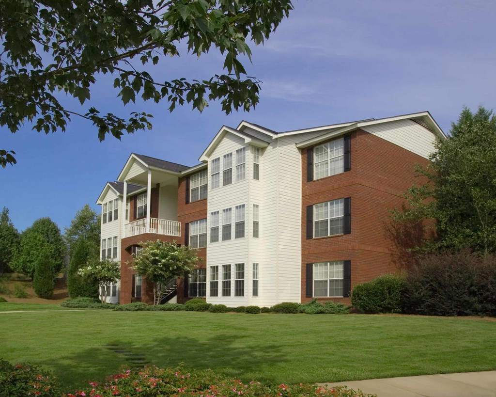 A large two-story building with a balcony on the second floor.