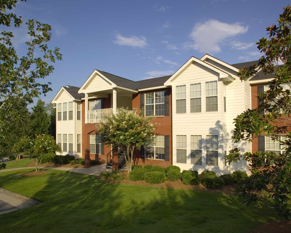 A large two story house with a white and brown exterior.