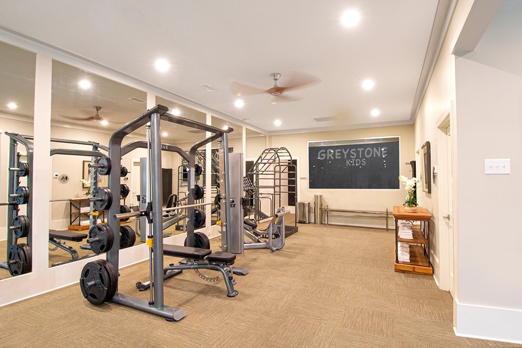 A gym with a sign that says "Greystone Kids".