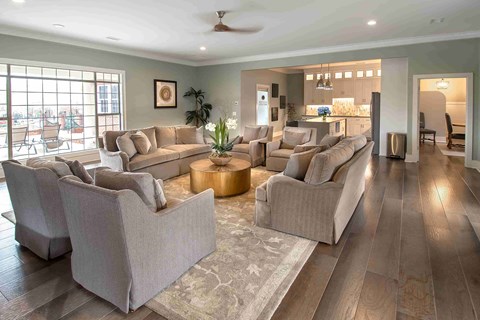 A living room with a large sectional sofa and a rug.