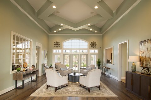 A living room with a large window and a rug on the floor.
