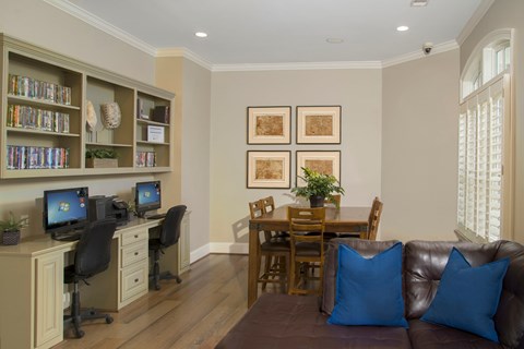A living room with a brown couch and a dining table.