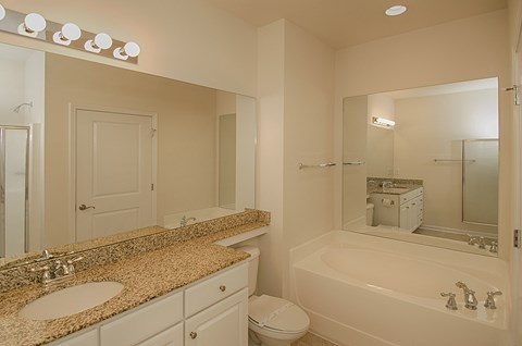 A white bathroom with a sink, toilet, and bathtub.