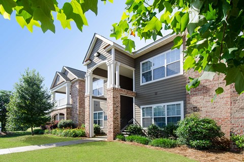 A house with a grey siding and a white trim.