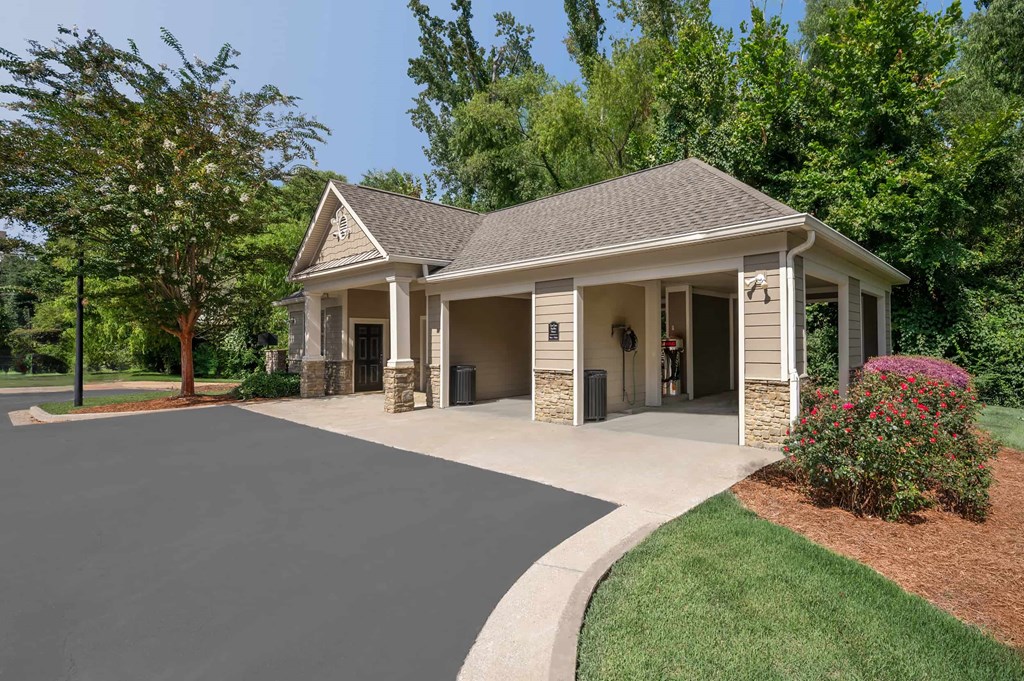 A house with a grey roof and a driveway in front.