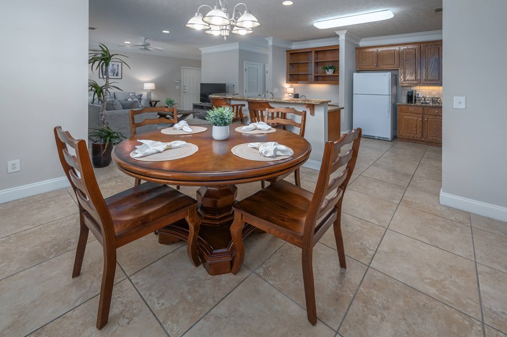 A dining room with a table set for four.