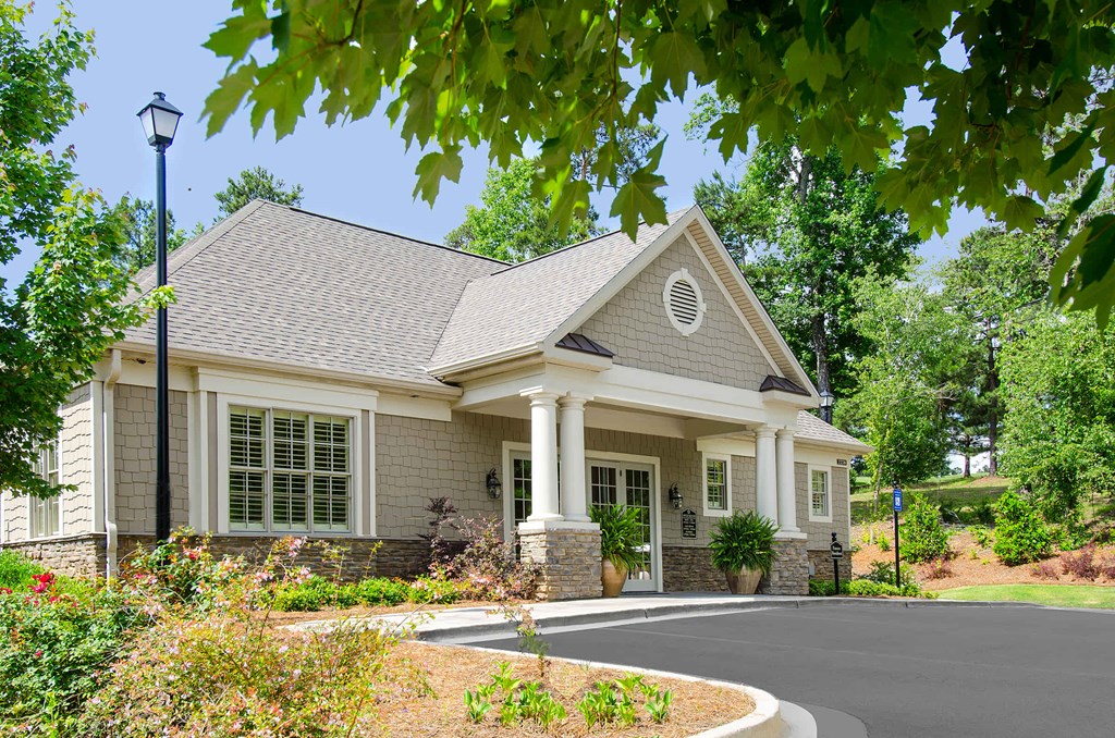 A house with a grey roof and white columns.