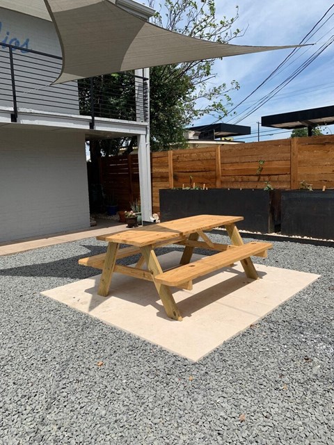 a picnic table sitting in front of a building