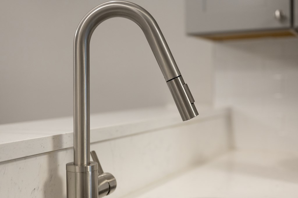 A chrome kitchen faucet with a pull-down sprayer.