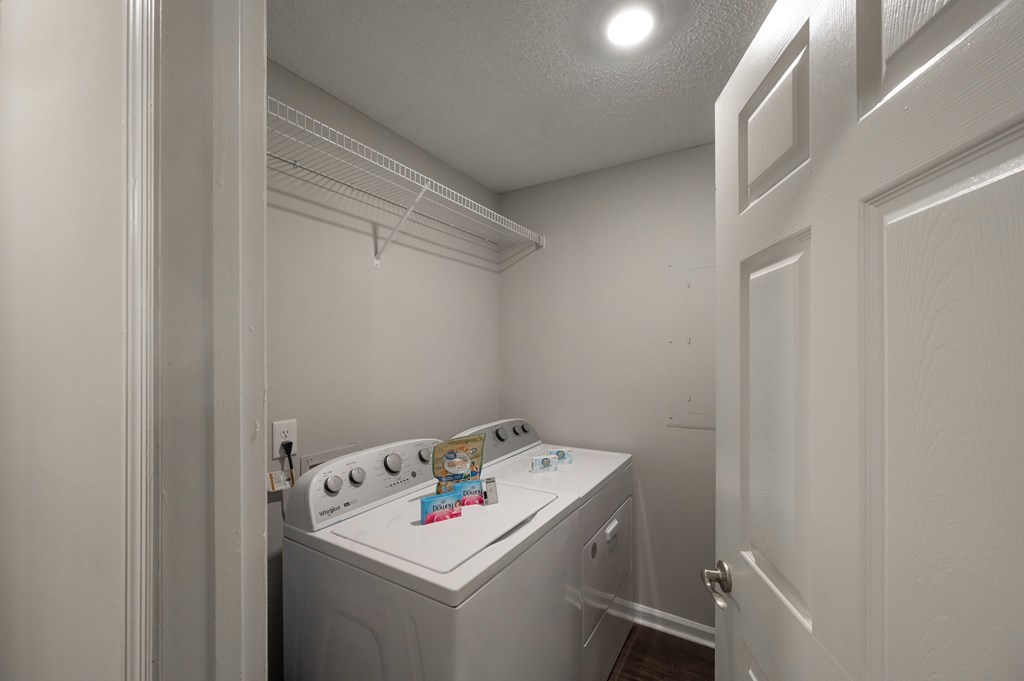 A small white washer and dryer in a laundry room.