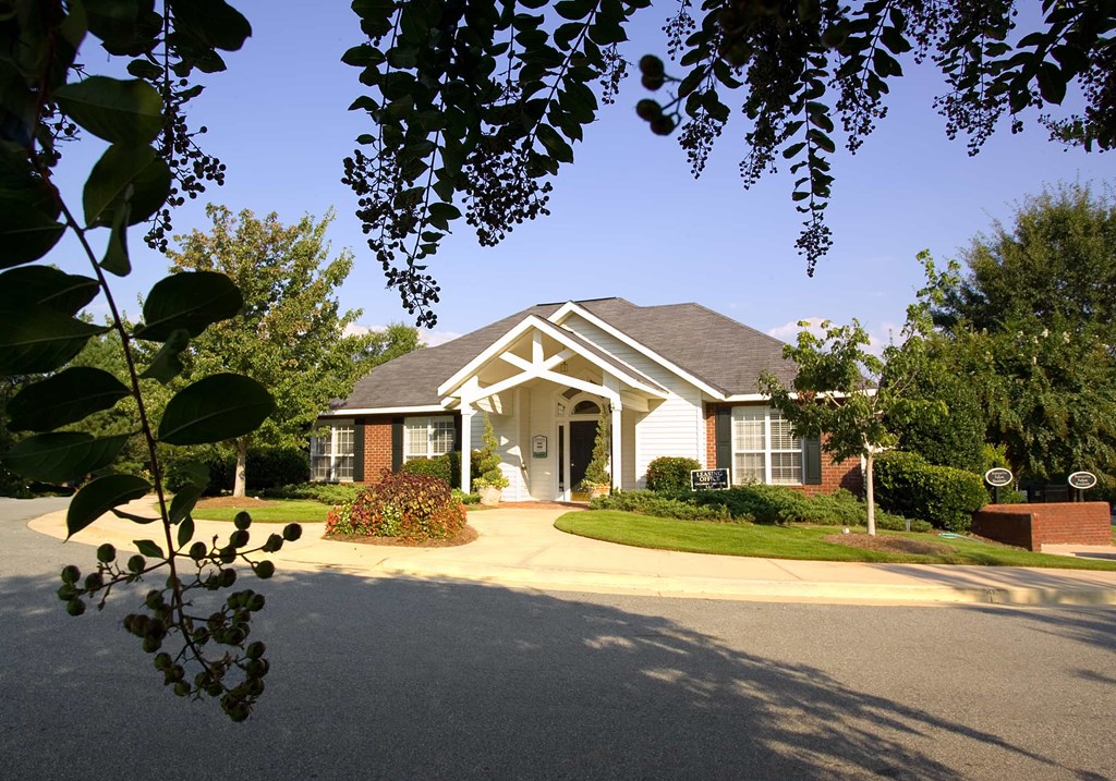 A house with a white front door and a brick pillar.