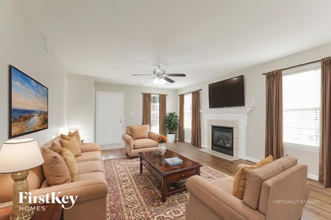 A living room with a fireplace and a painting on the wall.