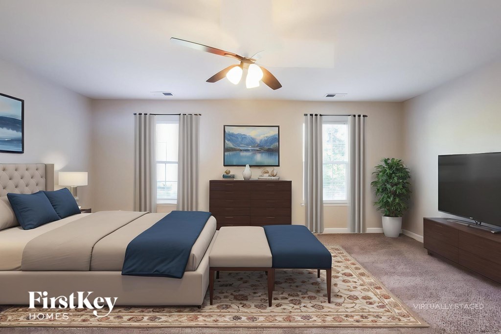A bedroom with a large bed and a flat screen TV.