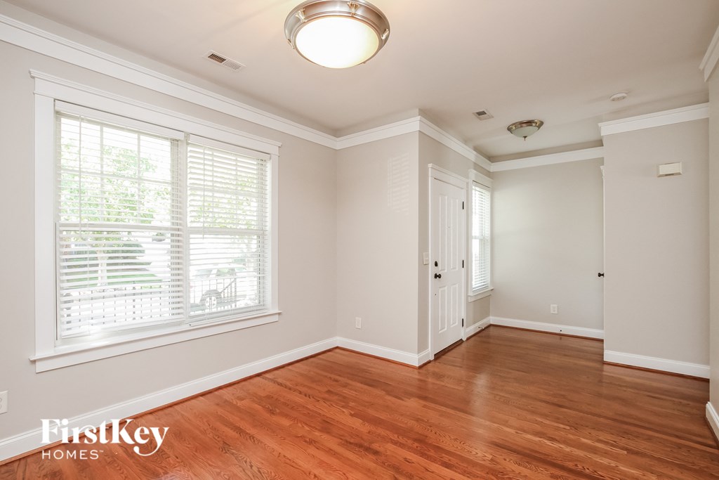 A room with wooden floors and white walls.