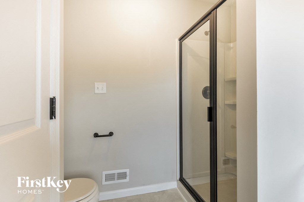 a small bathroom with a shower and a toilet