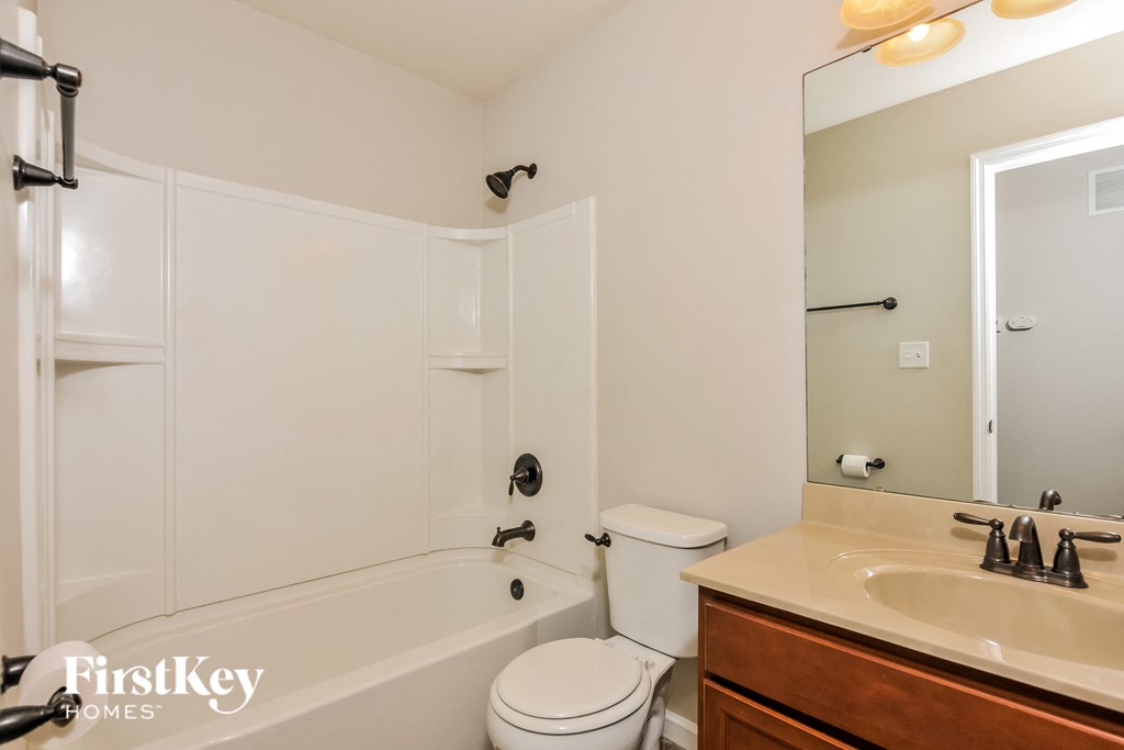 a bathroom with a sink toilet and bath tub