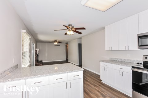 A kitchen with white cabinets and a countertop.