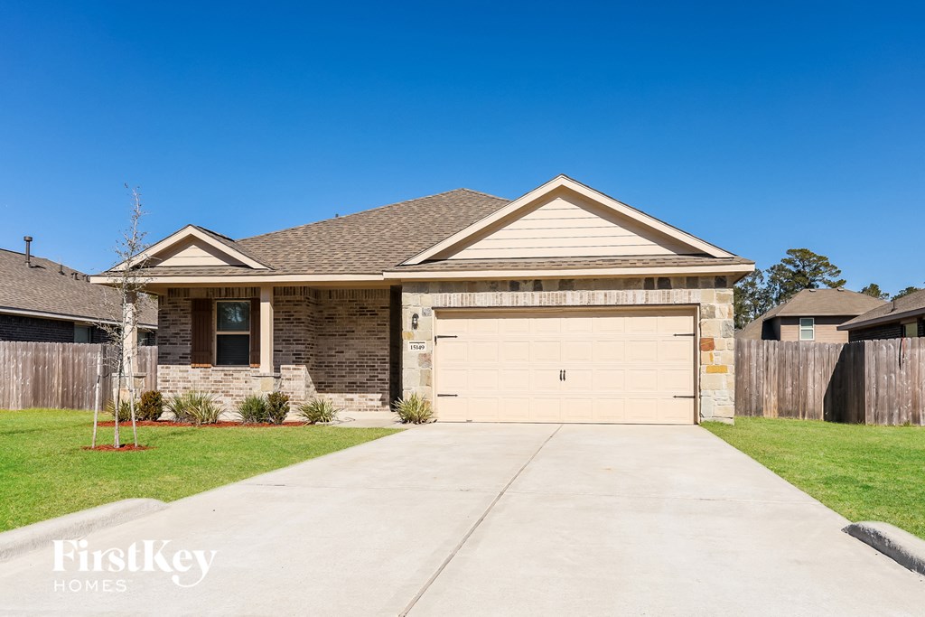 a brick house with a white garage door in front of it