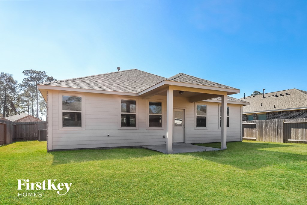 a white bungalow with a porch and a grass yard