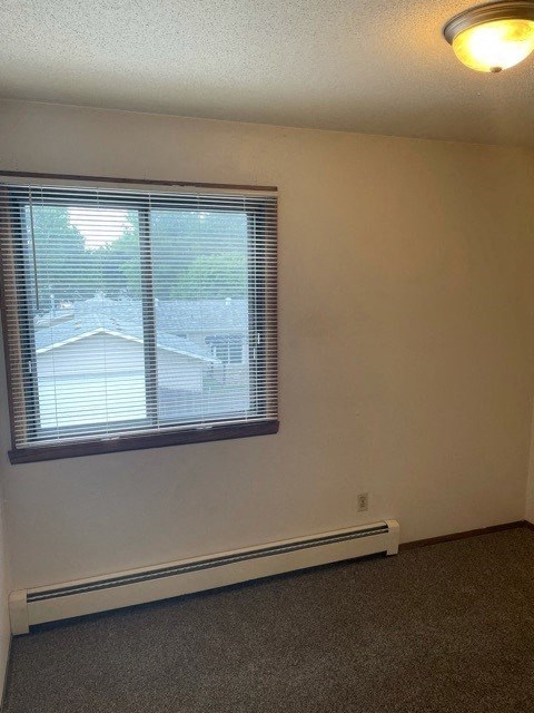 an empty room with a window and a lamp