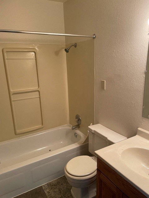 a bathroom with a toilet and a tub and a sink