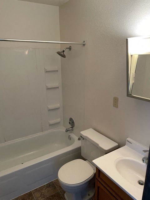 a bathroom with a toilet and a tub and a sink